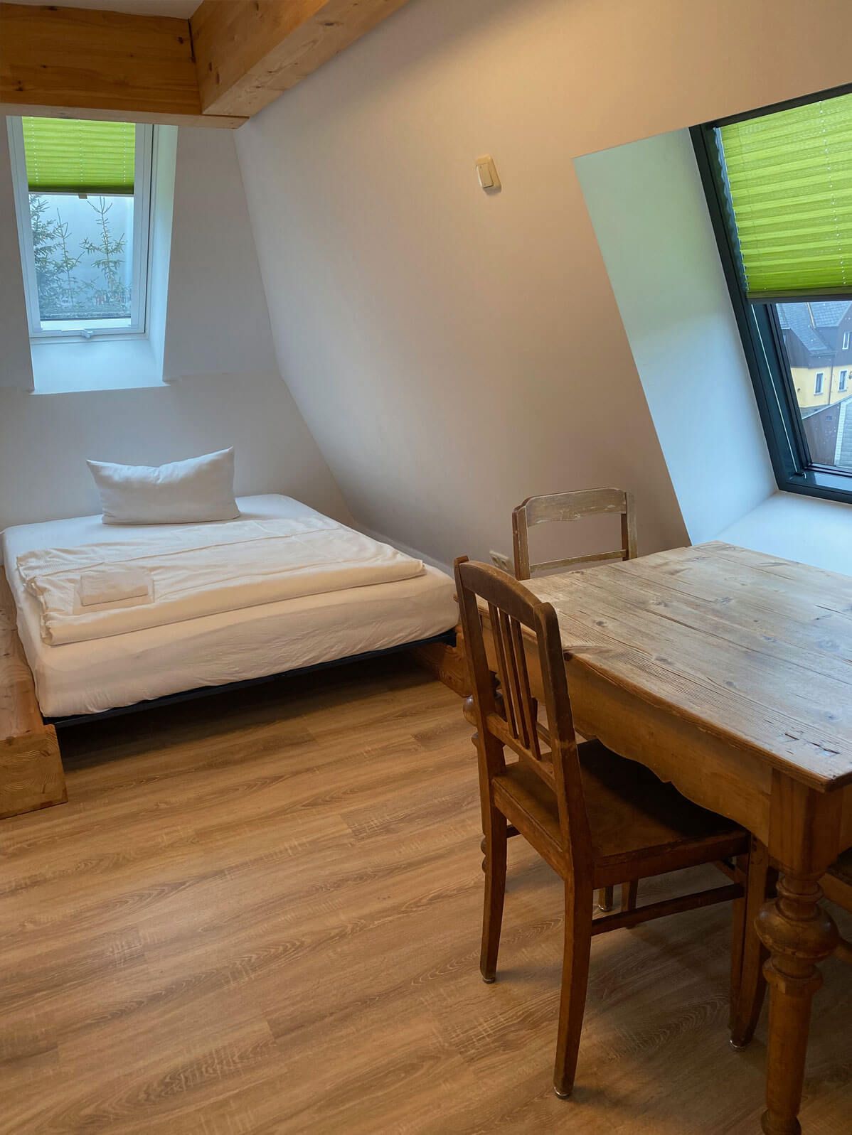FASA-Lodge Appartment Obergeschoss Bett und Schreibtisch unter Dachschräge